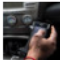  image of hand holding a phone while driving